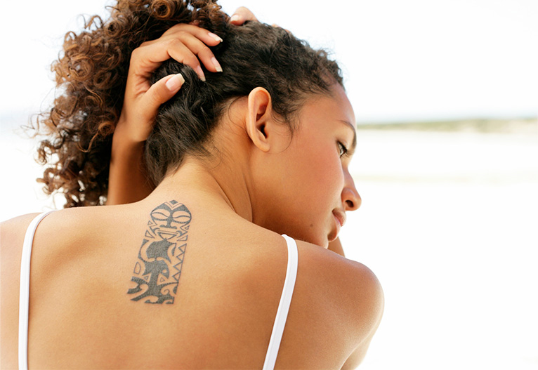 Woman with a tattoo on her back.