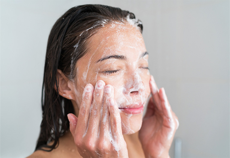Woman cleansing her face.