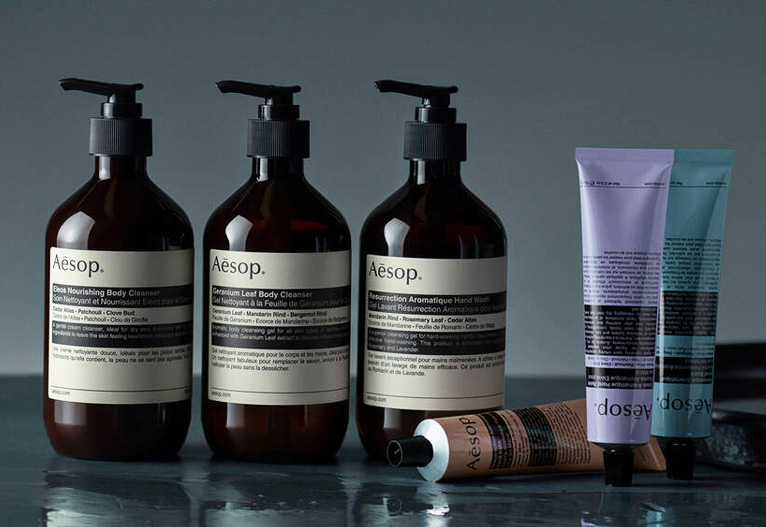 Aesop hand care products on a dark benchtop.