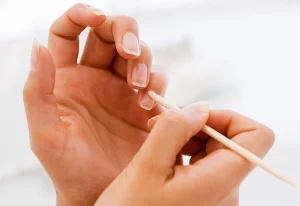 Person caring for their fingernails.