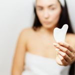 Woman holding a gua sha.
