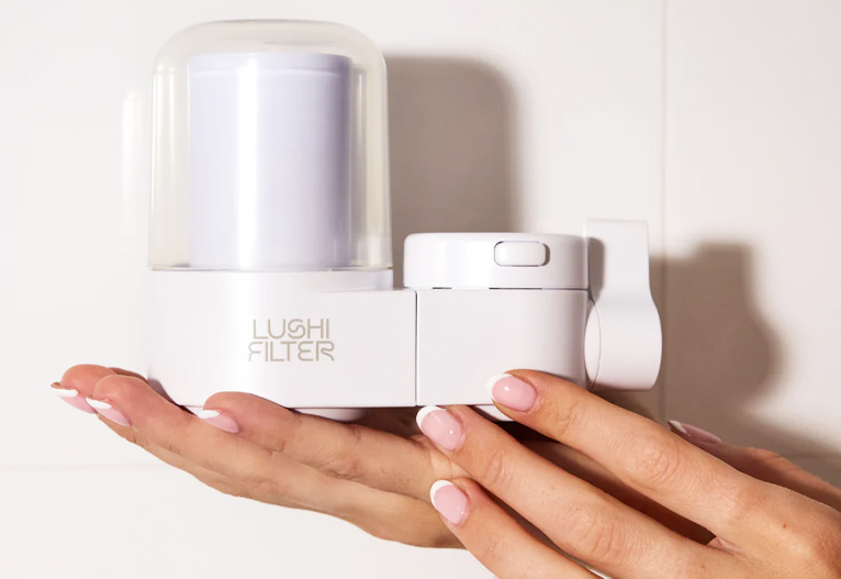 Person holding the Lushi Skincare Water Filter.