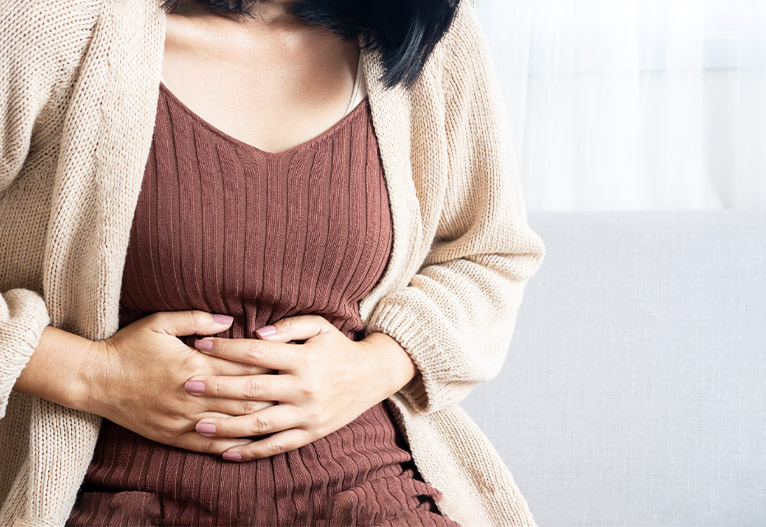 Woman holding her stomach.