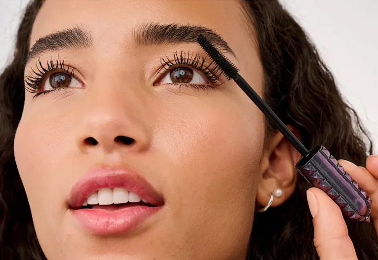 Woman applying mascara.