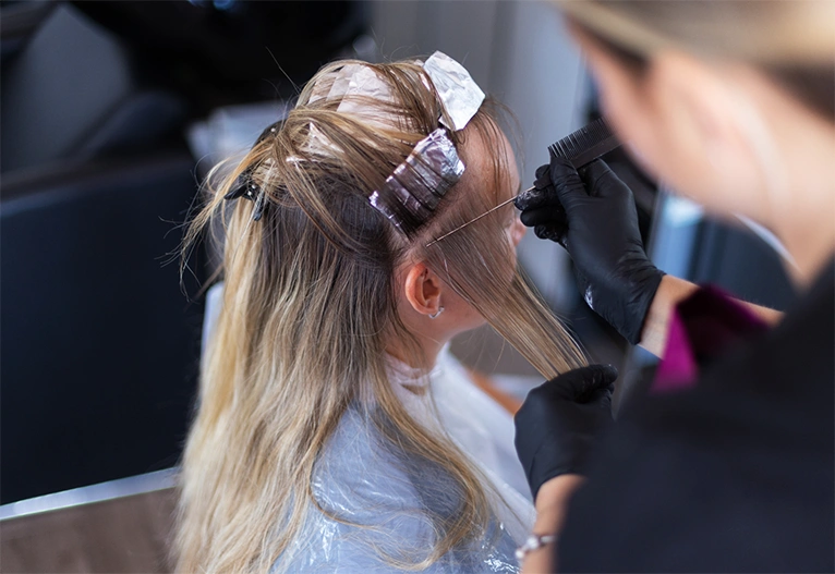 Woman having foils put in her hair.
