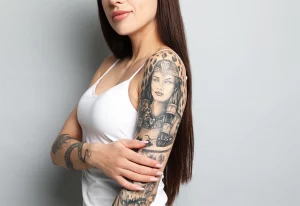 Woman with arm tattoos.