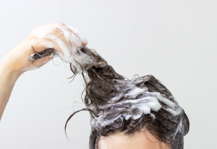 Person washing their hair.